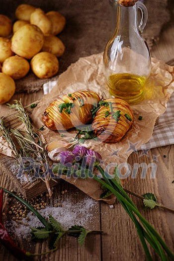 Sliced baked potatoes over wooden background. Rustic style. Sliced baked potatoes over wooden background. Rustic style.