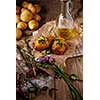 Sliced baked potatoes over wooden background. Rustic style.