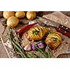 Sliced baked potatoes over wooden background. Rustic style.