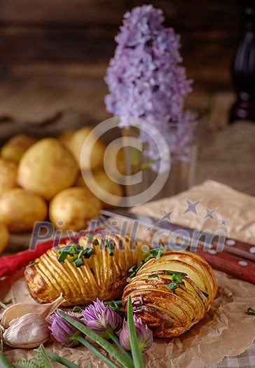 Sliced baked potatoes over wooden background. Rustic style. Sliced baked potatoes over wooden background. Rustic style.