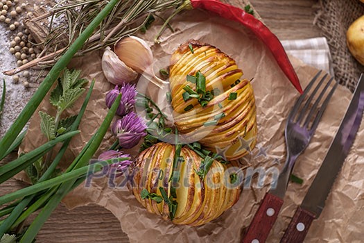 Sliced baked potatoes over wooden background. Rustic style. Sliced baked potatoes over wooden background. Rustic style.