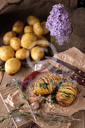 Sliced baked potatoes over wooden background. Rustic style. Sliced baked potatoes over wooden background. Rustic style.