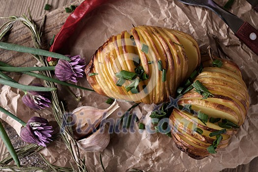 Sliced baked potatoes over wooden background. Rustic style. Sliced baked potatoes over wooden background. Rustic style.