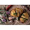 Sliced baked potatoes over wooden background. Rustic style.