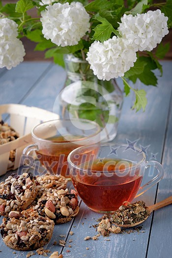 Cup of tea and cookies made of nuts and raisins. Kozinaki.