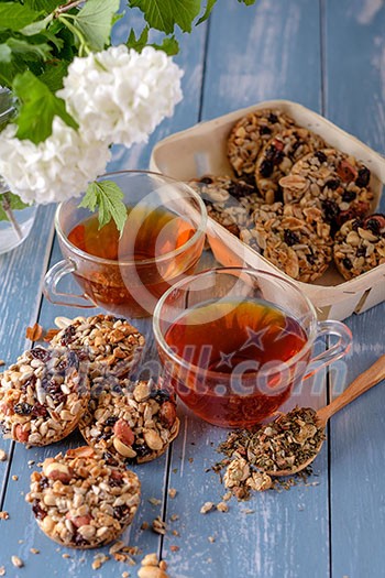 Cup of tea and cookies made of nuts and raisins. Kozinaki.