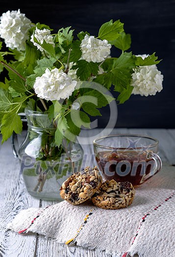 Cup of tea and cookies made of nuts and raisins. Kozinaki.