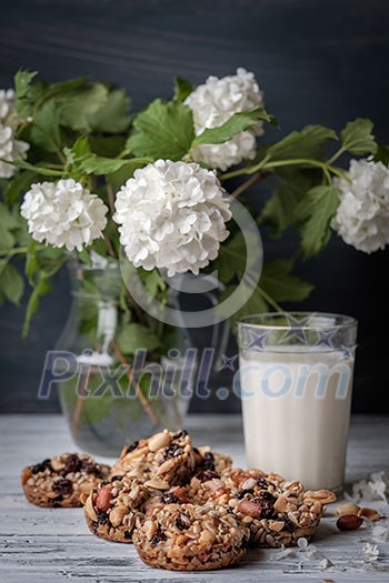 Glass of milk and cookies made of nuts and raisins. Kozinaki.