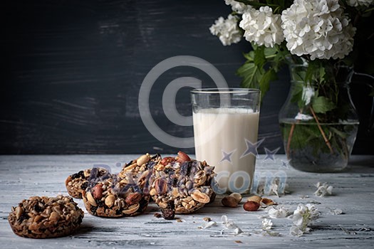 Glass of milk and cookies made of nuts and raisins. Kozinaki. Glass of milk and cookies made of nuts and raisins. Kozinaki.