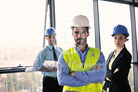 business people group on meeting and presentation in bright modern office with construction engineer architect and worker looking building model and blueprint planbleprint plans business people group on meeting and presentation in bright modern office with construction engineer architect and worker looking building model and blueprint planbleprint plans