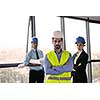 business people group on meeting and presentation  in bright modern office with construction engineer architect and worker looking building model and blueprint  plans