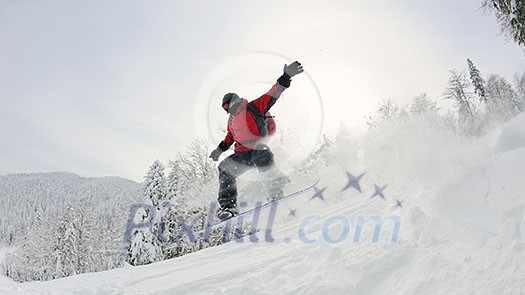 Snowboarder doing a jump and free ride on  powder snow at winter season