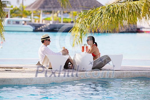 happy young couple relax and take fresh drink at summer vacation happy young couple relax and take fresh drink at summer vacation