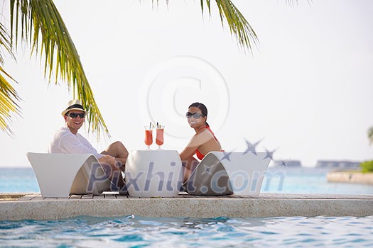 happy young couple relax and take fresh drink at summer vacation happy young couple relax and take fresh drink at summer vacation
