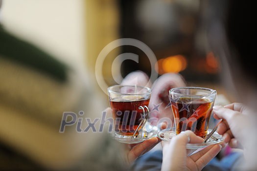 happy Young romantic couple and relaxing sofa in front of fireplace at winter season in home happy Young romantic couple and relaxing sofa in front of fireplace at winter season in home