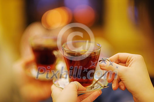 happy Young romantic couple sitting on sofa in front of fireplace at winter season in home