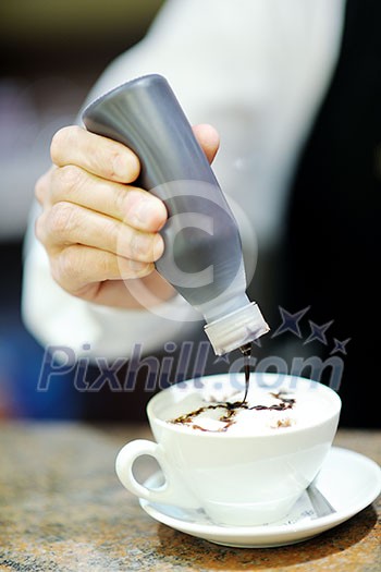 Barista prepares cappuccino in his coffee shop Barista prepares cappuccino in his coffee shop