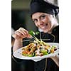 beautiful young chef woman prepare and decorating tasty food in kitchen