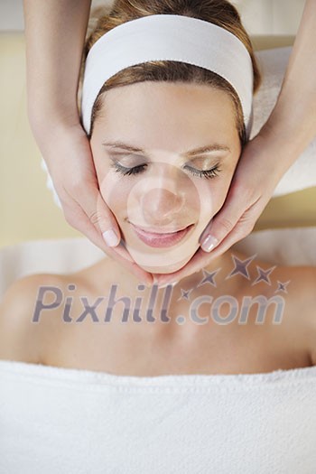 Beautiful young woman in spaand wellness. Face back and stone massage Beautiful young woman in spaand wellness. Face back and stone massage