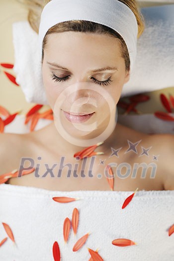 Beautiful young woman in spaand wellness. Face back and stone massage Beautiful young woman in spaand wellness. Face back and stone massage