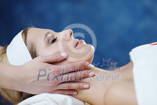 Beautiful young woman in spaand wellness. Face back and  stone massage