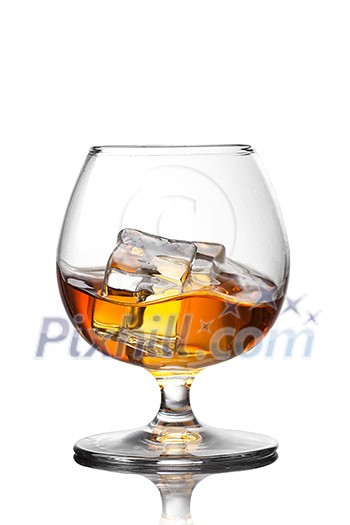 Splash of whiskey with ice in glass isolated on white background Splash of whiskey with ice in glass isolated on white background