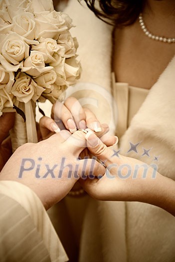 puttting on a wedding ring. stylized photo puttting on a wedding ring. stylized photo
