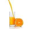 orange juice poring into glass isolated on white