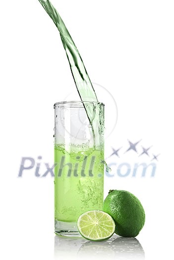 green juice with lime pouring into glass isolated on white green juice with lime pouring into glass isolated on white