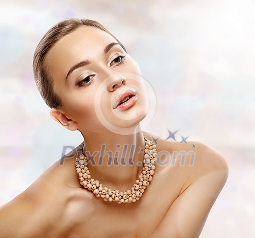 Beauty Portrait. Girl with necklace. Perfect Fresh Skin. Isolated on White Background. Pure Beauty Model. Youth and Skin Care Concept