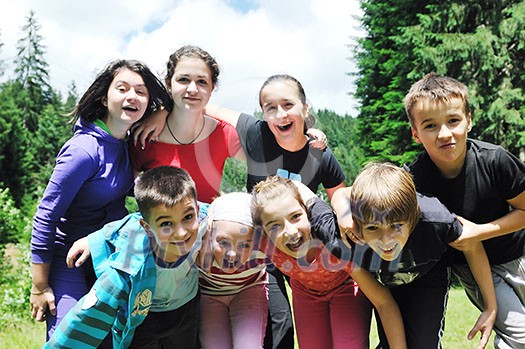 happy children group  have fun outdoor in nature at suny day