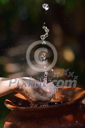 splashing fresh  water drops on girl soft skin  care for sensuality woman hands
