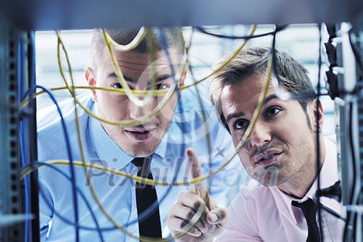 group of young business people it engineer in network server room solving problems and give help and support group of young business people it engineer in network server room solving problems and give help and support