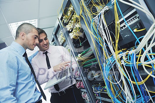 group of young business people it engineer in network server room solving problems and give help and support group of young business people it engineer in network server room solving problems and give help and support