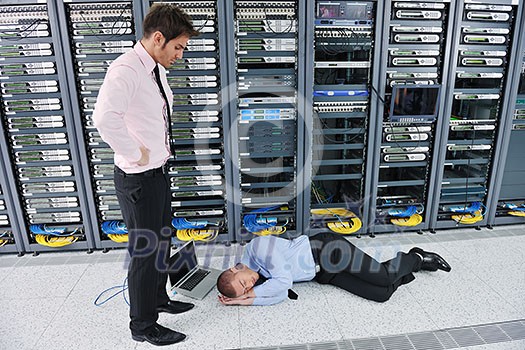 it business man in network server room have problems and looking for disaster situation solution it business man in network server room have problems and looking for disaster situation solution