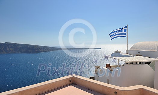 greece flag in wind at day with blue background