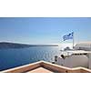 greece flag in wind at day with blue background