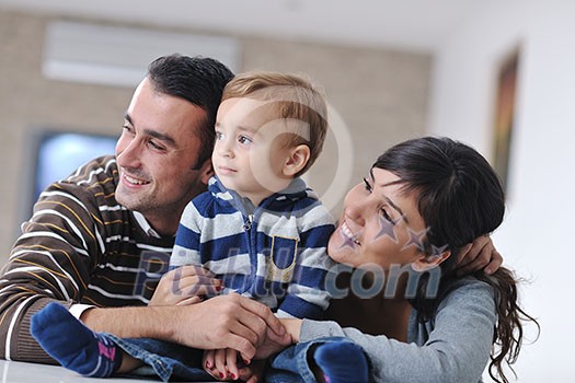 happy young family have fun and relaxing at new home with bright furniture happy young family have fun and relaxing at new home with bright furniture