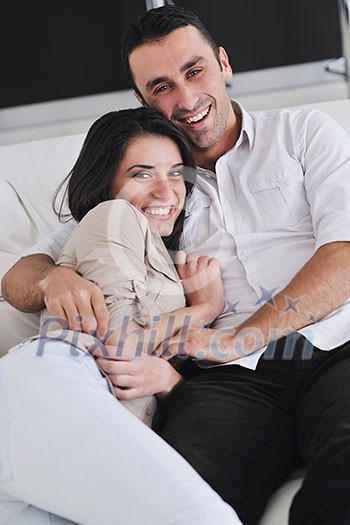 happy young couple relax at modern home living room indoor happy young couple relax at modern home living room indoor