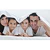 happy young Family in their bedroom have fun and play in bed