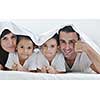 happy young Family in their bedroom have fun and play in bed