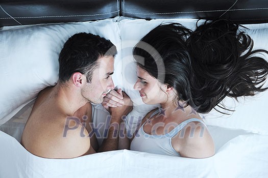 happy young healthy people couple have good time in their bedroom make love and sleep happy young healthy people couple have good time in their bedroom make love and sleep