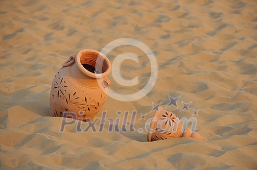 antique art old arabic pot in sand