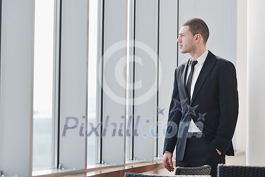 young business man lawyer with laptop alone in big bright conference room young business man lawyer with laptop alone in big bright conference room