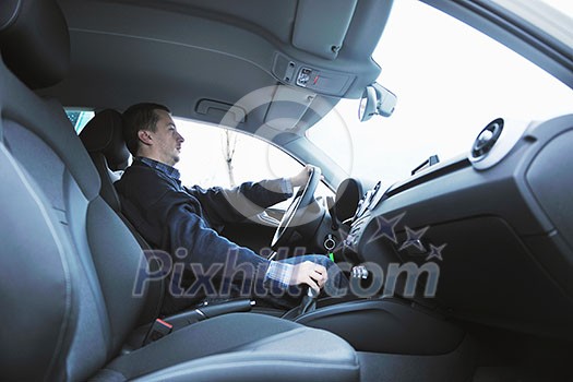 young man using new car navigation and onboard vehicle transport system young man using new car navigation and onboard vehicle transport system