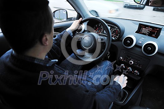 young man using new car navigation and onboard vehicle transport system young man using new car navigation and onboard vehicle transport system