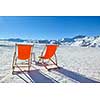 chair on top of mountain range at winter season sunny day with blue sky in background representing concept of relax