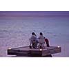 romantic couple  in love have dinner in outdoor restaurant with candles with sea in background