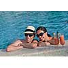 happy young couple relax and take fresh drink at summer vacation on swimmin pool