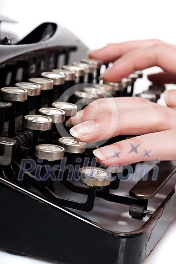 fingers on vintage typing machine on white fingers on vintage typing machine on white